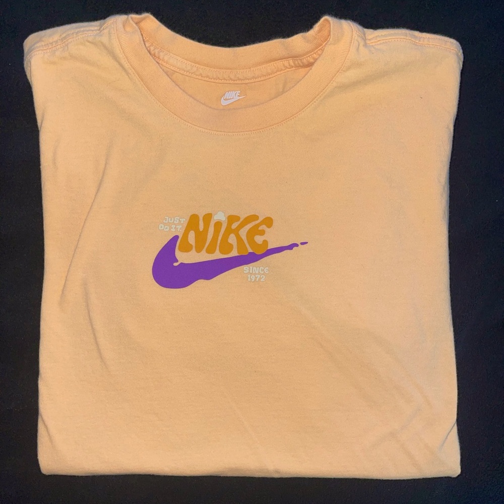 Peach Nike logo T-shirt.